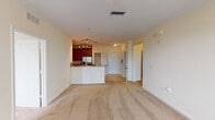 Located at Tapestry Park in Jacksonville, Florida, this single-floor residence offers a well-designed open-concept layout that seamlessly connects the kitchen and living areas. The kitchen is a standout feature, showcasing rich cherry wood cabinetry, granite-style countertops, stainless steel appliances including a refrigerator, range, and microwave, and a peninsula with bar seating that overlooks the main living space. Track lighting illuminates the kitchen, while tile flooring adds a clean, practical finish.

The expansive living area is finished with plush wall-to-wall carpeting and crown molding, and benefits from generous natural light through multiple windows and a glass exterior door. A ceiling fan provides added comfort throughout the space.

The bedrooms continue the carpeted theme and feature large windows that frame views of surrounding greenery, creating a bright and tranquil atmosphere. The bathrooms are well-appointed, with cherry wood vanities, granite-style countertops, tiled flooring, and full soaking tub and shower combinations. The primary bathroom includes a dual-sink vanity with a wide mirror and elegant lighting.

A dedicated laundry area houses a stacked full-size washer and dryer, adding everyday convenience to this thoughtfully designed residence.