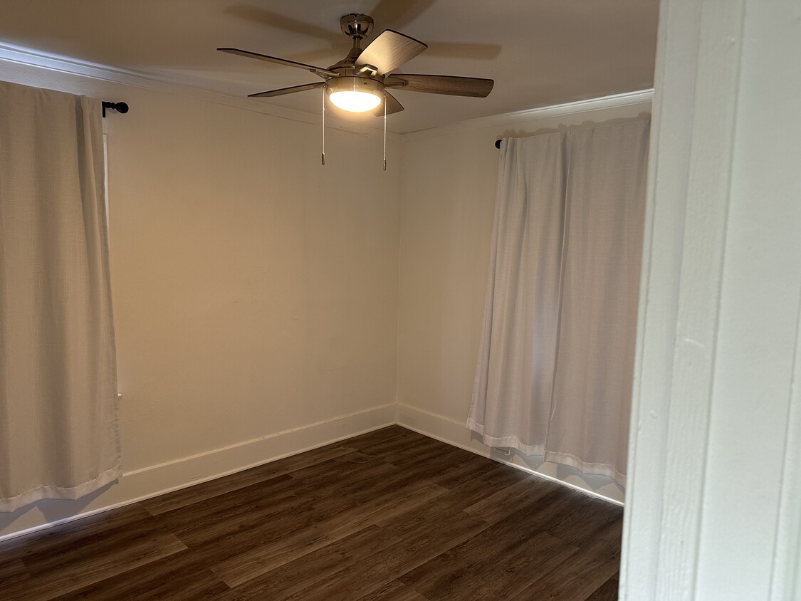 Walk in closer with lighted ceiling fan. Good sized bedroom perfect for a queen sized bed. - 5027 2nd Ave