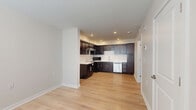 Located at 2281 E 89th St in Cleveland, OH, this single-floor, one-bedroom, one-bathroom unit offers a thoughtfully designed layout that maximizes every square foot. The open-concept kitchen and living area serves as the heart of the space, featuring rich dark espresso cabinetry that extends floor to ceiling, light-toned countertops, a subway tile backsplash, and stainless steel appliances including a dishwasher and over-the-range microwave. A peninsula adds additional counter space and storage, while recessed lighting keeps the area bright and welcoming. Light hardwood flooring runs throughout the main living areas, lending warmth and visual continuity. The bedroom is a comfortable, well-proportioned retreat with neutral walls, hardwood flooring, natural light from a window, and a double-door closet offering ample storage. The bathroom is clean and functional, featuring a tiled tub-shower combination, tile flooring in warm beige tones, and chrome fixtures. Additional conveniences include a dedicated laundry area, a utility room, and a closet for extra storage. The overall aesthetic is modern and understated, with a neutral color palette and clean finishes that create a calm, move-in-ready environment.