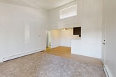 Located at 1211 S Quebec Way, this one-bedroom, one-bathroom residence is thoughtfully laid out across a single floor, making efficient use of its compact footprint. The living room is a standout space, featuring soaring vaulted ceilings that create an airy, open atmosphere, a classic corner fireplace with a clean white surround, and sliding glass door access to a private balcony. Natural light filters in through the vertical blinds, enhancing the bright, neutral palette throughout. Baseboard heating is present in both the living room and bedroom, ensuring year-round comfort. The galley-style kitchen is well-appointed with dark espresso cabinetry, light countertops, stainless steel appliances including a refrigerator, dishwasher, and range, and light hardwood-style flooring that extends into the hallway and bathroom. The bedroom is generously sized, featuring plush carpeting, a window with natural light, a textured ceiling, and direct access to a dedicated closet with louvered doors. The bathroom is clean and functional, with a full tub-shower combo, light wood-style flooring, and simple, classic finishes. A connecting hallway ties all rooms together for a cohesive and practical flow throughout the home.