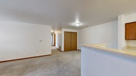 Located at 5200 Cambridge Ln in Mount Pleasant, Michigan, this single-story home offers four bedrooms and two full bathrooms within a well-organized floor plan. The layout is connected by a central hallway that provides straightforward access to all rooms throughout the home.

The living area features neutral carpet flooring and benefits from natural light through a windowed exterior door, creating a bright and open feel. The kitchen is positioned adjacent to the living space, separated by a half-wall counter that adds a functional room divider.

Each of the four bedrooms is carpeted and finished with warm wood-toned trim and baseboards. The bedrooms feature built-in closets with bifold doors, offering practical storage. Several bedrooms include windows with blinds, allowing for natural light and ventilation. The primary bedroom provides a comfortable amount of space and direct closet access.

Both bathrooms feature wood-look vinyl flooring and warm wood-toned cabinetry. Each bathroom is equipped with a single-sink vanity with a mirrored medicine cabinet above, and a full tub and shower combination. The clean, white walls throughout the bathrooms and the rest of the home create a bright, neutral palette well-suited to a variety of interior styles.
