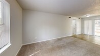 Located at 5495 Countryside Dr in Winston-Salem, NC, this one-bedroom, one-bathroom unit offers a practical and efficiently arranged single-floor layout. The combined kitchen and living area forms the heart of the unit, with the living space featuring neutral-toned carpet and clean white walls that create a bright, open feel. Natural light filters in, lending the room a welcoming ambiance. The entry area transitions from wood-look luxury vinyl flooring into the carpeted living space, providing a clear delineation between zones.

The kitchen is well-equipped with white cabinetry offering ample storage, dark granite-style countertops, and a full suite of black appliances including a range, dishwasher, and refrigerator. Wood-look flooring runs throughout the kitchen, complementing the crisp cabinetry. A textured ceiling is consistent throughout the unit.

The bedroom is a comfortable size, featuring plush carpet, a closet, and a window that brings in natural light with views of surrounding greenery. The room connects conveniently to the hallway, which leads to the full bathroom. The bathroom includes a tub-shower combination with chrome fixtures, keeping the space functional and straightforward. Overall, the unit presents a clean, neutral palette suited for easy personalization.