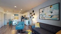 Located in Aurora, Colorado, this two-story residence offers a well-designed layout that blends functionality with contemporary style. The open-concept main living area seamlessly connects the living room and kitchen, creating an inviting, airy atmosphere. The kitchen is outfitted with stainless steel appliances, including a refrigerator, range, and over-the-range microwave, complemented by crisp white cabinetry, a tile backsplash, and light countertops. Wood-look flooring flows throughout the main level, adding warmth and continuity to the space. The living room features neutral walls that provide a versatile backdrop, with a large window allowing natural light to filter in and offer views of the surrounding neighborhood. Multiple bedrooms are carpeted for comfort, each providing a quiet retreat. The bathrooms are finished with white vanities, light countertops, and wood-look flooring; one includes a full tub-shower combination. A dedicated laundry area houses a full-size washer and dryer, adding everyday convenience. Spanning two floors, the layout provides a practical separation between living and sleeping areas, making this Aurora residence a functional and modern home.