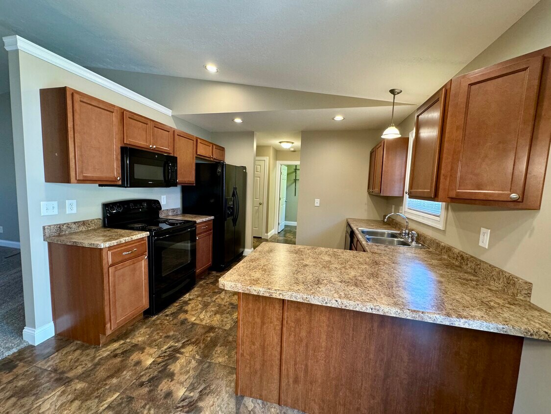 View of kitchen from dining area, kitchen counter bar. - 1341 Easy St