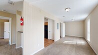 Located at 6565 Spencer Hwy in Pasadena, TX, this single-story, 4-bedroom, 2-bathroom home offers a practical and comfortable layout designed to maximize everyday living. The interior is finished with warm neutral tones throughout, with plush carpeting in the living and bedroom areas and hardwood-style flooring in the kitchen and bathrooms.

The kitchen is outfitted with honey-toned wood cabinetry, dark granite-style countertops, and black appliances including a range, dishwasher, and refrigerator, all set atop warm wood-look flooring. Each of the four bedrooms features ceiling fans, carpeted floors, and windows that bring in natural light. The generously sized primary bedroom includes sliding glass door access and ample closet space with built-in shelving rods. Additional bedrooms offer comparable comfort with vertical blind-covered windows.

Three closets throughout the home provide excellent storage capacity. Both bathrooms are equipped with tub-shower combinations finished in neutral tile, paired with wood-look flooring for a cohesive look. A connecting hallway ties the layout together efficiently. The overall ambiance is clean, functional, and move-in ready, making this home well-suited for those seeking comfort and practicality in a single-level residence.