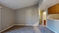 Located at 3501 San Clemente Ave in Modesto, CA, this two-bedroom, two-bathroom home offers a well-organized single-floor layout designed for comfortable everyday living. The living room serves as the heart of the home, featuring a tile-surround fireplace, soft carpeting, and a sliding glass door that opens to a private patio, allowing natural light to fill the space. Neutral taupe walls and vaulted ceilings contribute to an open, airy feel throughout. The kitchen is efficiently laid out with warm oak cabinetry extending to the ceiling for ample storage, stainless steel appliances including a refrigerator, range, and over-the-range microwave, and light countertops. A half-wall peninsula connects the kitchen to the living area, creating an open flow between spaces. Both bedrooms are carpeted and finished with the same neutral tones, each featuring windows that bring in natural light and views of the surrounding greenery. The primary bedroom includes a dedicated closet and direct access to one of the two full bathrooms. Each bathroom is equipped with a tub-shower combination, wood-toned vanity cabinetry, and hardwood-style flooring. Two closets provide additional storage throughout the home.