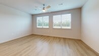 Located at 11305 Grant Rd in Houston, TX, this well-appointed single-story, 2-bedroom, 2-bathroom home offers a clean, modern aesthetic throughout. Light wood-tone flooring flows seamlessly across the entire living space, creating a warm and cohesive feel. The open kitchen is a standout feature, showcasing crisp white shaker cabinetry, granite-style countertops, a subway tile backsplash, and stainless steel appliances including a refrigerator, range, and microwave. A kitchen island provides additional prep and serving space. The combined kitchen and living area creates an open, functional layout ideal for everyday living. Both bedrooms are bright and airy, each equipped with a ceiling fan and windows dressed with horizontal blinds that frame views of the surrounding greenery. The spacious primary bedroom offers generous proportions and connects to dedicated closet space. Each of the two full bathrooms features white cabinetry with granite countertops, a tub-shower combination with floor-to-ceiling marble-look tile surround, and wood-tone flooring. Both bedrooms are complemented by walk-in closets outfitted with wire shelving systems, maximizing storage efficiency. The home's neutral palette and consistent finishes throughout contribute to a light, clean, and move-in-ready atmosphere.