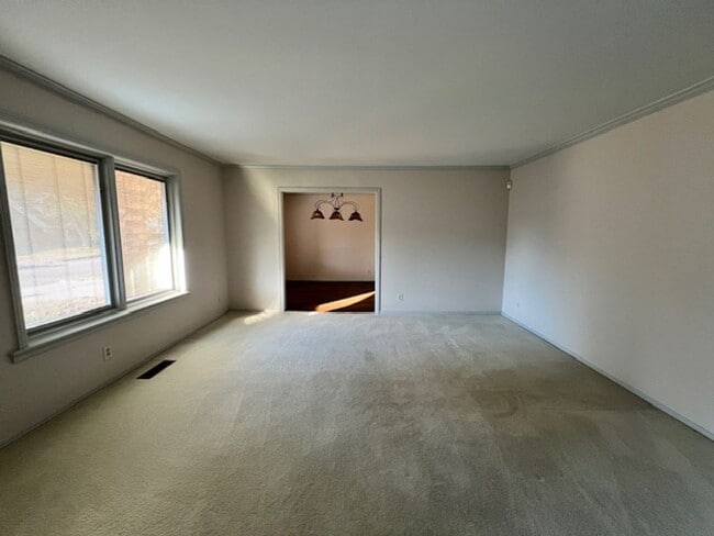 Building Photo - Step into this inviting, sunlit home where space and comfort blend seamlessly