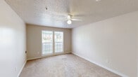 This single-floor residence at 430 Lash Dr in Salisbury, NC offers four bedrooms and two bathrooms within a practical and well-organized floor plan. Throughout the living areas and bedrooms, neutral-toned carpet flooring creates a warm, consistent aesthetic, complemented by beige walls and white trim that give the space a clean, understated look.

Each bedroom is fitted with a ceiling fan with integrated lighting, and windows allow natural light to filter in with views of the surrounding neighborhood. The spacious primary bedroom offers generous room for furnishings. The additional bedrooms are similarly carpeted and well-proportioned, each featuring multiple electrical outlets and natural light.

The two bathrooms are finished with light wood-style vinyl plank flooring. One bathroom is equipped with accessibility features, including grab bars near the toilet, making it suitable for a range of residents. The second bathroom includes a full shower-tub combination with a chrome towel bar.

The kitchen is outfitted with white appliances, including a refrigerator and range. A dedicated walk-in closet features wrap-around wire shelving, providing ample organized storage. Textured ceilings are present throughout, and the layout connects living areas and bedrooms via a central hallway, ensuring a logical and efficient flow throughout the residence.