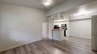 Located at 1325 W Tharpe St in Tallahassee, FL, this 2-bedroom, 2-bathroom unit offers a well-planned single-floor layout designed for comfortable everyday living. The open-concept living and dining area is finished with durable wood-style flooring and neutral tones throughout, creating a bright and cohesive atmosphere. Elevated ceilings in the main living space add a sense of openness beyond the unit's footprint.

The kitchen features white shaker-style cabinetry, granite-look countertops, and black appliances including a refrigerator, range, and built-in microwave. A breakfast bar connects the kitchen to the living and dining area, making it ideal for casual meals or entertaining. The kitchen also provides access to additional storage.

Both bedrooms are carpeted for comfort and receive natural light through window blinds with views of surrounding greenery. The primary bedroom includes its own closet, while a second closet provides additional storage. Each bathroom is finished with wood-look tile flooring, white vanities with brushed nickel hardware, and a full tub-shower combination.

Completing the layout is a dedicated laundry area, adding everyday convenience. The unit's clean finishes, functional design, and thoughtful use of space make it a practical and comfortable residence.