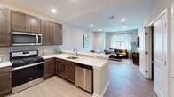 Located at The View in Fairfield, NJ, this thoughtfully designed 1-bedroom, 1-bathroom residence delivers a comfortable and modern living experience across a single floor. The open-concept layout seamlessly connects the kitchen, dining, and living areas, creating a bright and cohesive space filled with natural light from large windows dressed with elegant curtains and blinds.

The kitchen is a standout feature, showcasing rich dark-brown cabinetry, white quartz countertops, a subway tile backsplash, and a full suite of stainless steel appliances including a refrigerator, range, microwave, and dishwasher. A peninsula with bar seating provides a convenient casual dining option and enhances the open flow into the living area.

The living room offers a warm and inviting atmosphere with light hardwood-style flooring, neutral tones, and generous natural light from an oversized window with outdoor views. A dedicated in-unit laundry closet adds everyday convenience.

The bedroom is a serene retreat featuring plush carpeting, natural light from a large window, and ample space for furnishings. The full bathroom is finished with a dark-wood vanity, white quartz countertop, chrome fixtures, and a shower-tub combination with clean tile surround. Recessed lighting throughout the residence contributes to a polished, contemporary ambiance.