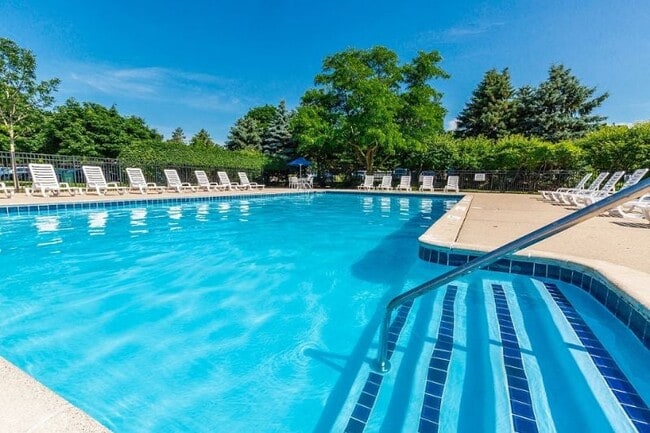 Heated Pool with lounge chairs at Dover Hills Apartments Kalamazoo MI - Dover Hills Apartments