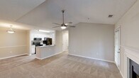 Located at 239 Ashcraft Cir in Pawleys Island, SC, this well-appointed 2-bedroom, 2-bathroom single-floor home offers a thoughtfully designed layout with a clean, neutral aesthetic throughout. The open-concept living area is a standout, featuring soaring vaulted ceilings, plush carpeting, and a ceiling fan that adds both comfort and style. A classic white-mantled fireplace serves as the focal point of the living room, flanked by windows that bring in natural light, with a glass door providing access to the outdoors. The kitchen is efficiently designed with white cabinetry, granite-look countertops, a peninsula with a built-in sink, and black appliances including a range, microwave, and refrigerator. Wood-look vinyl flooring runs through the kitchen and dining area, creating a seamless transition. A hallway leads to the two bedrooms, each carpeted and served by closets with wire shelving systems — including a spacious walk-in closet. Both bathrooms are finished with granite-topped vanities and wood-look flooring, with one featuring a tub/shower combination. A dedicated laundry room with full-size hookups and overhead shelving adds everyday convenience to this practical and comfortable home.