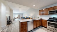 Located at 1610 Franklin Ave in Salem, Ohio, this single-story home offers a thoughtfully designed open-concept layout that promotes a seamless flow between living spaces. The interior is finished with light-toned hardwood-style flooring throughout the main areas, complemented by neutral wall tones that create a bright, welcoming atmosphere.

The kitchen is a functional centerpiece, featuring warm-toned cabinetry, white countertops, and stainless steel appliances including a gas range, built-in microwave, and dishwasher. A peninsula provides additional workspace and connects the kitchen to the adjacent dining and living areas. The dining space benefits from a large window with outdoor views, filling the area with natural light.

The living room showcases vaulted ceilings and a ceiling fan, enhancing the sense of openness. The bedroom is generously sized with plush carpeting, a ceiling fan, and a window that brings in natural light. The bathroom includes a wood-toned vanity with a wide countertop and shower.

The entryway features hardwood-style flooring and multiple doors offering convenient access throughout the home. Overall, this residence delivers a clean, modern aesthetic with practical, comfortable living spaces.