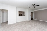 Located at 1615 N Cobb Pkwy in Marietta, Georgia, this single-floor residence offers a clean, modern aesthetic throughout its thoughtfully designed layout. The kitchen is outfitted with white shaker-style cabinetry, granite-look countertops, a stainless steel appliance suite including an electric range, and wood-look flooring that extends through the main living areas, providing a warm, durable surface underfoot.

The spacious living area features plush carpeting, crown molding, and a ceiling fan, with natural light streaming in through multiple windows and a set of glass doors that open directly onto a private outdoor deck — ideal for enjoying the surrounding greenery.

The bedrooms continue the carpeted flooring and are brightened by large windows with views of the outdoors, each equipped with ceiling fans for comfort. Ample closet storage is provided throughout.

The bathrooms are finished with white tile tub-surround accents, granite-topped white vanities, and the same wood-look flooring found in the kitchen, giving them a cohesive, polished appearance.

A dedicated in-unit laundry area with a top-load washer and overhead shelving adds practical convenience. The overall ambiance of the space is bright, neutral, and move-in ready, making it a functional and comfortable home in the heart of Marietta.