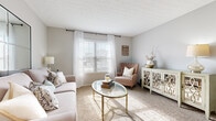 Located at 1038 Bayridge Dr in Lewis Center, Ohio, this well-appointed single-floor residence offers 1 bedroom and 2 bathrooms within a thoughtfully designed layout. The open-concept living, dining, and kitchen area forms the heart of the home, with the living room showcasing plush carpeting, a textured ceiling, and a bright window with blinds and sheer curtains that invite abundant natural light. The kitchen features dark cabinetry, stainless steel appliances including a range, microwave, and refrigerator, complemented by a white tile backsplash, light countertops, and wood-look flooring that extends into the dining area. The dining space is highlighted by a pendant light fixture and wood-look flooring. The bedroom is carpeted and bright, with a window allowing natural light and ample space for furnishings. A generously sized walk-in closet with wire shelving provides excellent storage. The two bathrooms include dark wood vanities, wood-look flooring, and a tub-shower combination. A dedicated in-unit laundry area accommodates a full-size washer and dryer. Neutral gray walls and consistent finishes throughout create a cohesive, modern ambiance ideal for comfortable everyday living.