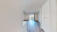 This 340 square foot studio apartment in Newport Beach offers a thoughtfully designed living space that maximizes functionality and style. The main living area is characterized by its open layout, featuring wood-look flooring that adds warmth and durability. Large sliding glass doors flood the space with natural light and provide access to a private balcony, perfect for enjoying the coastal air.

The apartment's efficient design includes a well-appointed bathroom with a modern white suite, including a full-size bathtub with shower and convenient built-in storage niches. The living area is equipped with a ceiling fan for comfort and a wall-mounted air conditioning unit for climate control.

White walls throughout create a bright, airy atmosphere, while baseboard heating ensures year-round comfort. The kitchenette, though not fully visible in the images, appears to be integrated into the main living space, maintaining the open feel of the apartment.

Despite its compact size, the studio offers ample room for a bed and living area furniture, making it an ideal space for single occupancy or a couple. The overall design aesthetic is clean and contemporary, providing a blank canvas for personalization while offering modern conveniences in a prime Newport Beach location.