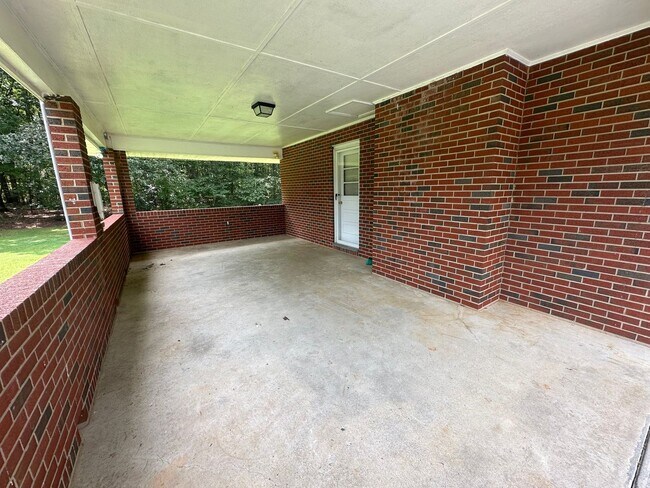 Building Photo - Spacious brick house with a caport and unf...