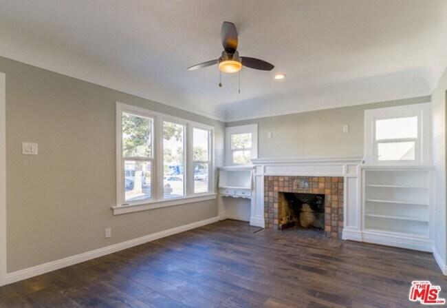 Living area features Built-in shelving, a large walk-in storage closet and a decorative Batchelder fireplace! - 1816 Browning Blvd