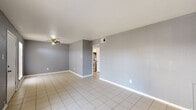 Located at 3603 Alice Street in Houston, TX, this single-floor, 2-bedroom, 1-bathroom unit offers a practical and comfortable layout. The living room features neutral gray walls, light-toned tile flooring, and an open sightline into the kitchen, creating a connected and airy feel. Natural light enters through a window fitted with blinds, brightening the space throughout the day.

The kitchen is efficiently designed with white cabinetry, dark granite-style countertops, a double-basin sink, and tile flooring. It accommodates a full-size refrigerator and a range, providing all essential appliances in a compact, galley-style arrangement.

Both bedrooms are finished with light wood laminate flooring, gray-toned walls, and ceiling fans — adding both comfort and practicality. Each room benefits from natural light through windows with blinds. The primary bedroom is a well-proportioned space with its own closet access. A second closet is also available within the unit for additional storage.

The bathroom includes a full tub-shower combination with white tile surround, a toilet, and tile flooring, presenting a clean and functional design. A hallway connects the main living areas to the bedrooms and bathroom, giving the layout a clear and organized flow throughout.