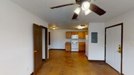 Located at 1634 14th St in Corpus Christi, Texas, this single-floor unit offers a straightforward and functional layout. The open living area is finished with polished concrete floors in warm amber tones, complemented by ceiling fans with integrated lighting that provide both comfort and illumination throughout the space. The electrical panel is conveniently accessible from the main living area.

The kitchen is well-equipped and designed for practicality, featuring warm oak cabinetry that extends to the upper walls for ample storage. White appliances include a coil-burner electric range, over-the-range microwave, and a full-size refrigerator. A double-basin sink and laminate countertops complete the functional cooking space, all lit by a bright overhead fluorescent fixture.

The bedroom is a calm, well-proportioned room with white walls, polished concrete flooring, and a ceiling fan with light kit. Two windows dressed with blinds allow natural light to filter in, creating a bright and comfortable atmosphere.

The bathroom includes a full-size soaking tub and shower combination with white surround panels, a toilet, and a storage cabinet above. Tile flooring and a grab bar add practical touches to the space. Overall, the unit presents a clean, no-frills interior well-suited for everyday living.