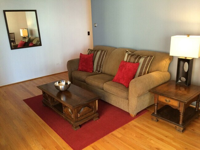 Living room with a comfy sofa and a 50" TV - 8200 E Jefferson Ave
