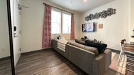 This contemporary apartment, located at 1012 S Main St in Moscow, Idaho, offers a spacious 1060 square feet of living area spread across two floors. The lower level comprises 480 square feet, while the upper floor extends to 580 square feet. The property boasts four bedrooms, including a primary bedroom of 130 square feet, and four full bathrooms, providing ample privacy for multiple occupants.

The interior showcases a modern design with a neutral color palette, emphasizing clean lines and functional spaces. The kitchen features stainless steel appliances, dark wood cabinetry, and a light-colored countertop, creating a sleek and efficient cooking area. The living room is furnished with a comfortable sectional sofa, perfect for relaxation and entertainment.

Bedrooms are well-lit with large windows offering picturesque views of the surrounding area. Built-in closets with mirrored sliding doors maximize storage space. The bathrooms are elegantly appointed with modern fixtures, glass shower enclosures, and stylish vanities.

Throughout the apartment, you'll find a harmonious blend of materials, including wood-look flooring and plush carpeting in select areas. The space is further enhanced by thoughtful decor elements such as contemporary artwork and area rugs, contributing to a cohesive and inviting atmosphere.

This apartment is ideal for those seeking a balance of comfort, style, and functionality in a prime Moscow location.