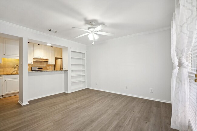 Living Room with Custom Made Bookcase - 6800 Glenridge Dr Townhome