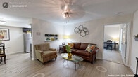 Located in Chapel Hill, NC, this well-appointed 2-bedroom, 2-bathroom single-floor home offers a thoughtfully designed layout with comfortable living spaces throughout. The inviting living room features wood-look flooring, a ceiling fan with light fixture, and a fireplace with a decorative mantel — creating a warm and functional centerpiece for the space. The open-flow layout connects the living area to a well-equipped kitchen outfitted with dark espresso cabinetry, granite-style countertops, stainless steel appliances, and a pass-through that opens to the dining area. The spacious primary bedroom is carpeted for comfort, features multiple windows that bring in natural light and views of surrounding greenery, and includes a walk-in closet with built-in shelving. The second bedroom is equally comfortable, with plush carpeting and ample space. Both bathrooms are finished with dark vanity cabinetry, white countertops, and shower/tub combinations with curved curtain rods. A hallway connects the bedrooms and bathrooms, maintaining a clean and efficient floor plan. Two dedicated closets provide generous storage throughout. The clean, neutral palette and consistent finishes give the home a cohesive and move-in-ready feel.