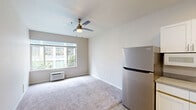 Located at 737 SW 17th Ave in Portland, Oregon, this one-bedroom, one-bathroom unit offers a practical and well-organized layout across a single floor. The open-concept living, dining, and kitchen area forms the heart of the unit, creating a cohesive space for everyday living. The kitchen is outfitted with white shaker-style cabinetry, stone-look countertops, light wood-tone flooring, and a full suite of stainless steel appliances including a refrigerator, electric range, and built-in microwave. A pantry provides additional storage, keeping the kitchen area tidy and functional. The living area features soft carpeting, a ceiling fan with lighting, a wall-mounted HVAC unit, and a broad window that draws in natural light and views of the surrounding neighborhood. The bedroom is a quiet, carpeted retreat with its own window for natural light and a mirrored sliding-door closet, offering convenient storage. A dedicated closet adds further organization to the space. The bathroom includes a full soaking tub and shower combination with a clean white surround, a single vanity with a stone-look countertop, and an accessibility grab bar. Neutral tones and clean finishes throughout give the unit a cohesive, move-in-ready feel.