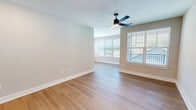 Located at 640 Lakeside Dr in Canton, GA, this thoughtfully designed 2-bedroom, 2-bathroom home offers a clean, modern aesthetic throughout its single-floor layout. The open-concept kitchen and living area serves as the heart of the home, featuring white shaker cabinetry, stainless steel appliances, a marble-style tile backsplash, and light wood-tone flooring that extends seamlessly into the living space. Ceiling fans provide comfort in the main living area, which is bathed in natural light through large windows with views of the surrounding neighborhood.

The spacious primary bedroom includes its own en-suite bathroom finished with wood-look flooring, a white vanity with quartz countertop, a glass-enclosed walk-in shower with tile surround, and direct access to a walk-in closet with wire shelving. The second bedroom is carpeted with a ceiling fan and a window offering natural light. The second full bathroom features a tub-shower combo with a marble-look surround, matte black fixtures, and a white vanity. Both closets are equipped with wire shelving systems. Neutral wall tones and matte black hardware details unify the home's contemporary style throughout.