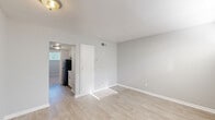 Located at 510 Broadway in Columbus, GA, this efficiently designed one-bedroom, one-bathroom unit makes thoughtful use of its compact footprint across a single floor. The living area welcomes natural light through blinded windows and features light wood-style flooring that extends throughout the main spaces, creating a clean and cohesive aesthetic. Neutral gray walls keep the interior feeling bright and airy.

The kitchen stands out with crisp white shaker cabinetry, granite countertops with subtle gray and beige veining, and a black refrigerator — a stylish combination that balances modern updates with practical functionality. A tile backsplash adds a subtle decorative touch.

The bedroom is a comfortable, carpeted retreat complete with a ceiling fan, a wide closet with sliding doors, and a built-in desk nook — an ideal feature for those who work or study from home. A wide window allows natural light to filter in, enhancing the room's warmth.

The bathroom features a full tub-shower combination with classic cream tile surround and chrome fixtures, offering a clean and functional space. Throughout the unit, white trim and baseboards provide a polished finish. The entry door area also benefits from natural light through an adjacent window, making arrivals feel welcoming.