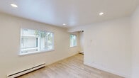 Located at 910 Camino Pescadero in Goleta, CA, this thoughtfully updated one-bedroom, one-bathroom unit offers a clean, modern aesthetic throughout. Light wood-style flooring flows seamlessly across all rooms, creating a warm and cohesive look complemented by crisp white walls and recessed lighting.

The kitchen is a standout feature, boasting white shaker cabinetry with brushed nickel hardware, a striking marble-look tile backsplash, light stone countertops, a double stainless steel sink, and stainless steel appliances including a gas range with overhead microwave. A ceiling fan and window allowing natural light complete this functional and stylish space.

The spacious bedroom is generously sized, featuring a large window with views of surrounding greenery, a baseboard heating unit, and recessed lighting that keeps the room feeling bright and airy. A hallway with closet access connects the living spaces efficiently.

The bathroom showcases elegant floor-to-ceiling marble-style tile in the walk-in glass-enclosed shower, paired with a sleek vanity featuring stone countertops and gold-toned hardware accents. The overall design maintains a cohesive, upscale aesthetic.

Natural light from multiple windows is present throughout the unit, enhancing the open and refreshing atmosphere of this well-appointed Goleta residence.