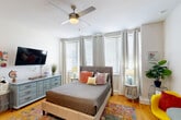 Located at 925 Common St in the heart of New Orleans, LA, this efficiently designed studio offers a well-organized single-floor layout that maximizes every square foot. The open-plan main area seamlessly integrates the living, dining, and kitchen functions into one cohesive space. The kitchen is outfitted with rich wood-tone cabinetry, a white countertop, a glass tile backsplash, and a full suite of stainless steel appliances including a refrigerator, dishwasher, and microwave, all illuminated by overhead track lighting.

The sleeping and living area is bright and welcoming, featuring warm hardwood flooring, a ceiling fan, and multiple windows dressed with blinds and grommet curtains that invite generous natural light. A vibrant area rug, colorful accent chairs, and curated artwork add a lively, contemporary character to the space.

The hallway connects to three closets, providing notable storage for a unit of this size. The bathroom is cleanly appointed with a warm wood vanity, white subway tile, a glass-enclosed walk-in shower, and tile flooring. Recessed lighting throughout and a neutral white palette create a bright, airy ambiance, making this a functional and stylish urban retreat in downtown New Orleans.