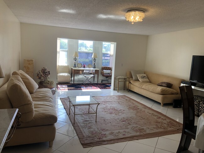 Main room with sunroom in distance - 2400 NE 1st Ln