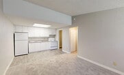Located in Cutler Bay, FL, this single-story 1-bedroom, 1-bathroom unit offers a practical and well-organized layout across a compact footprint. The open living area features neutral-toned carpet, textured ceilings, and a ceiling fan, creating a comfortable and functional space. Large windows allow natural light to filter in, enhancing the airy feel of the room. The kitchen is positioned adjacent to the living area and is equipped with white cabinetry, a white appliance suite including a range and refrigerator, a built-in sink, and overhead fluorescent lighting — all designed for efficient use of space. A hallway connects the main living areas to the private bedroom, which includes its own ceiling fan, carpeted floors, and a window with blinds for natural light and privacy. Three closets throughout the unit provide generous storage options. The bathroom features a clean, white tub-shower combination, a vanity, and wood-look tile flooring. A dedicated utility room adds functional convenience, while the patio offers an outdoor retreat. Neutral gray walls and consistent finishes throughout give the unit a cohesive, move-in-ready appearance.