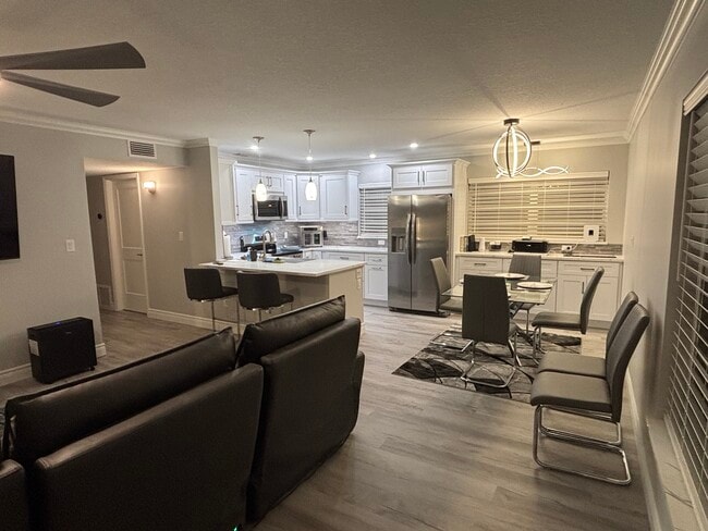 Living room and kitchenView from front door. Electric reclining modular sofa with lounger. - 10 Vista Palm Ln