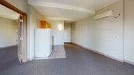 This 520 square foot apartment in Des Moines, Iowa offers a well-designed living space with modern touches. The single-floor layout comprises one bedroom, measuring a generous 220 square feet, and two bathrooms for added convenience. The open-plan living area combines the kitchen and living room, creating a sense of spaciousness. The kitchen features bright orange cabinetry, adding a pop of color to the neutral palette. Gray carpeting in the living areas contrasts with light wood-look flooring in the kitchen and bathrooms. Large windows in the bedroom provide ample natural light and scenic views. The bathrooms are equipped with modern fixtures, including a tiled shower-tub combination in soft mint green. Climate control is ensured with a wall-mounted air conditioning unit. Ample storage is provided through built-in closets with louvered doors. The apartment's efficient design maximizes the use of space, making it an ideal urban dwelling for singles or couples seeking a contemporary living environment.