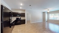 Located at 4702 Ambassador Way in Balch Springs, Texas, this single-story home presents a clean, contemporary interior designed for comfortable everyday living. The layout flows openly between the main living area and kitchen, both finished with light wood-look flooring that runs consistently throughout the home, contributing to a cohesive and spacious feel.

The kitchen is a functional centerpiece, featuring an L-shaped configuration with rich dark espresso cabinetry, light granite-style countertops, and a full suite of black appliances including a gas range, built-in microwave, dishwasher, and refrigerator. Ample upper and lower cabinet storage enhances practicality.

The living area benefits from natural light through blinds-fitted windows, complemented by a ceiling fan overhead. Multiple rooms throughout the home share the same warm flooring and neutral taupe wall tones, creating a unified aesthetic. Each room includes windows that bring in outdoor views and natural light.

The bathroom features large-format tile flooring, a dark vanity with a white countertop, a well-lit mirror, and a full tub-shower combination with brushed nickel fixtures. Closets with built-in rods provide ample storage within the bedrooms, rounding out this well-organized, move-in-ready home.
