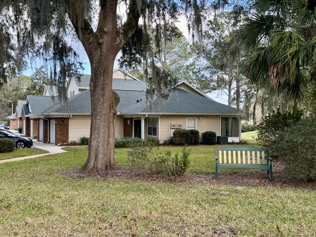 Corner unit overlooking an old golf course and side public green space with live oaks. - 13200 W Newberry Rd