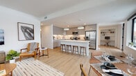 Located at 4111 E Ninth Ave in Denver's vibrant 80220 neighborhood, this modern single-floor residence offers a thoughtfully designed open-concept layout with clean lines and contemporary finishes throughout. Light wood flooring flows seamlessly across the main living areas, creating a warm, cohesive aesthetic.

The expansive kitchen is a standout feature, outfitted with high-gloss gray cabinetry, white quartz countertops, stainless steel appliances, and a large center island with bar seating. Pendant lighting anchors the space, which opens directly into the dining area and living room — an ideal configuration for entertaining. The dining area benefits from oversized black-framed windows that frame urban city views and fill the space with natural light.

The living room is bright and welcoming, with large windows offering additional city views. The bedrooms are comfortably sized with plush carpeting, generous windows, and a calm, neutral palette. Each bathroom reflects the same modern sensibility, featuring floating white vanities, large-format tile, and clean, minimalist fixtures — one offering a walk-in layout with built-in shelving, and another with a tub-shower combination and wood-look flooring. A dedicated office or flex space rounds out this well-appointed home.