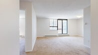 Located at 1551 Riverside Dr in Ottawa, this one-bedroom, one-bathroom unit offers a practical and functional floor plan across a single level. The layout includes a living room, kitchen, bedroom, bathroom, and hallway, making efficient use of the available space.

The living room features neutral-toned carpet flooring and a built-in closet, providing a clean and versatile area for everyday living. Large sliding doors and windows allow natural light to fill the room while offering views of the surrounding neighbourhood.

The bedroom is a comfortable, well-proportioned room with soft carpet flooring, a textured ceiling, and a baseboard heating unit. A large window invites natural light and overlooks the exterior surroundings, creating a bright and airy atmosphere.

The kitchen is outfitted with white cabinetry spanning both upper and lower sections, light stone-effect countertops in an L-shaped configuration, a stainless steel sink, and light tile flooring — providing ample storage and workspace.

The bathroom includes wood-look vinyl flooring, a white vanity with a granite-style countertop, a toilet, and a full bathtub with tiled surround, completing the unit's practical amenities.

Overall, the unit presents a clean, neutral palette throughout, making it a versatile space well-suited for comfortable residential living.