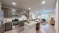 Located at 11918 Clay Road in Houston, TX 77043, this well-designed one-bedroom, one-bathroom unit offers a thoughtfully organized layout across a single floor. The open-concept kitchen and living area serves as the centerpiece of the unit, featuring rich gray shaker-style cabinetry, a white subway tile backsplash, and a full suite of stainless steel appliances including a French door refrigerator, range, microwave, and dishwasher. A granite-topped kitchen island with bar seating provides additional prep space and a casual dining option. Wood-style plank flooring flows seamlessly throughout, lending a cohesive, contemporary feel. The living area is bright and inviting, benefiting from a large window and a ceiling fan overhead. The bedroom is a comfortable, well-proportioned space with natural light from a window, a ceiling fan, and direct access to a walk-in closet outfitted with wire shelving. The bathroom features a soaking tub with subway tile surround, a vanity, and wood-style flooring consistent with the rest of the unit. A dedicated laundry area accommodates a full-sized washer, adding notable everyday convenience to this efficiently designed Houston residence.