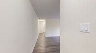 Located at 53 Mcmurchy Ave N in Brampton, Ontario, this 2-bedroom, 1-bathroom unit offers a well-organized and functional layout across a single floor. The living room is generously proportioned, featuring grey laminate wood flooring and soft, neutral-toned walls that create a clean and welcoming atmosphere. Large sliding doors open directly onto a private balcony, where residents can enjoy views of lush greenery, mature trees, and well-maintained lawns — a refreshing outdoor retreat.

Both bedrooms continue the cohesive aesthetic with matching laminate flooring and warm beige walls. The primary bedroom includes a window overlooking the surrounding building exterior, while the second bedroom features a built-in sliding-door closet, offering practical storage. Each room benefits from natural light and baseboard heating units.

The bathroom is finished with light ceramic tile flooring and beige tile surround in the tub-shower combination, complemented by a clean white vanity and toilet. The overall design is straightforward and functional.

The unit's two balconies — one facing green space and another with a street-level tree-lined view — add to the appeal of this well-maintained residential space in a landscaped community setting.