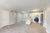 Located at 225 W Fourth St in downtown Wilmington, DE, this 2-bedroom, 2-bathroom unit offers a clean, modern layout designed for comfortable everyday living. The open-concept kitchen and living area serves as the heart of the home, featuring white shaker cabinetry, a subway tile backsplash, stainless steel appliances including an electric range, dishwasher, and refrigerator, and a peninsula with a single-basin sink that provides additional prep space and separates the kitchen from the living area. Light wood-style flooring runs consistently throughout, contributing to a cohesive and contemporary feel. Neutral light gray walls keep the space feeling open and bright. The spacious primary bedroom is generously sized and features multiple windows that invite natural light and views of the surrounding neighborhood. The second bedroom is well-proportioned with the same light flooring and neutral palette. Both bathrooms are finished in a clean, understated style — one includes a soaking tub and modern fixtures, while the other offers a functional vanity and toilet setup. A dedicated closet provides additional storage. The overall design is modern and move-in ready, making this a well-appointed unit in the heart of Wilmington.