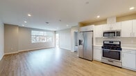 Located in the Ocean Beach neighborhood of San Diego, this single-floor residence at 3909 Voltaire St offers a clean, contemporary design throughout. The open-concept living and kitchen area is bright and welcoming, anchored by recessed lighting and light wood-style flooring that extends seamlessly through the space. Large windows allow natural light to fill the living area, creating an airy atmosphere with views of the surrounding neighborhood.

The kitchen is well-appointed with white shaker-style cabinetry, white quartz countertops, a stainless steel undermount sink, and a full suite of stainless steel appliances including a French door refrigerator with ice maker, gas range, built-in microwave, and dishwasher.

The bedrooms are generously sized, each featuring wood-style flooring, neutral wall tones, and ceiling fans. One bedroom includes sliding glass doors that open directly onto a private balcony with metal railings and neighborhood views.

The bathrooms maintain the home's modern aesthetic with white cabinetry, quartz countertops, undermount sinks, large mirrors, and glass-enclosed shower and tub combinations. The private outdoor balcony provides additional living space in the mild San Diego climate. Clean lines, neutral finishes, and thoughtful details define this well-designed residence.
