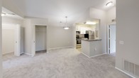 Located at 3800 Arbor Dr in Fenton, Michigan, this single-floor residence offers a thoughtfully designed layout with a bright, open feel throughout. The living area features soaring vaulted ceilings and large sliding glass doors that invite abundant natural light and provide views of the surrounding greenery, creating an airy and welcoming atmosphere. Neutral-toned carpet flows through the living spaces and bedrooms, complementing the warm, understated color palette of the interior.

The kitchen is efficiently designed in a galley-style configuration, showcasing white cabinetry, dark granite-style countertops, and a full suite of stainless steel appliances, including a refrigerator, range, microwave, and dishwasher. Light wood-look flooring ties the kitchen together with a clean, contemporary aesthetic.

The bedrooms are generously sized, each featuring plush carpeting, large windows with vertical blinds that allow for natural light and outdoor views, and ample closet space — including a walk-in closet in the primary bedroom fitted with built-in shelving. The bathrooms are well-appointed with bold marble-style vanity countertops, full tub-shower combinations with tiled surrounds, and bright vanity lighting. This residence combines practical functionality with comfortable, modern finishes throughout.