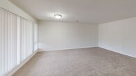 This 650 square foot apartment in Redford, Michigan, offers a thoughtful layout maximizing its single-floor design. The space features one bedroom and one bathroom, with the primary bedroom measuring a generous 180 square feet. The open-concept living area seamlessly integrates the kitchen and living room, creating a sense of spaciousness.

The kitchen is equipped with wooden cabinetry, providing ample storage, and white appliances including a refrigerator, stove, microwave, and dishwasher. Hardwood flooring in the kitchen adds warmth and durability. The living area boasts large windows, allowing natural light to flood the space, and is finished with plush carpeting for comfort.

The bathroom features a standard layout with a single vanity, toilet, and shower/tub combination. Oak cabinetry in the bathroom complements the kitchen's aesthetic. Throughout the apartment, neutral-toned walls create a blank canvas for personalization.

Safety features include a prominently placed fire extinguisher. The unit also comes with in-unit laundry facilities, adding convenience to daily living. Overall, this apartment offers a practical and comfortable living space, ideal for singles or couples seeking a low-maintenance lifestyle in a suburban setting.