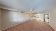 Located at 3300 Winterhaven St, Unit 203 in Las Vegas, NV, this two-bedroom, one-bathroom residence offers a practical and well-appointed single-floor layout. The open-concept living and kitchen area creates a welcoming, connected space, with soft carpet in the living zone transitioning to wood-look flooring in the kitchen. A ceiling fan with light fixture anchors the living area, complemented by track lighting that illuminates the kitchen.

The kitchen is neatly designed with white cabinetry, granite-style countertops, a subway tile backsplash, and white appliances including a range, built-in microwave, dishwasher, and refrigerator. A single-basin sink with a modern faucet rounds out the functional layout.

Both bedrooms are carpeted and include ceiling fans with light fixtures. The primary bedroom features a sliding-door closet with built-in shelving, while the second bedroom benefits from a window that brings in natural light. A hallway connects the bedrooms to the shared bathroom, which is finished with wood-look tile flooring, a granite-top vanity with white cabinetry, a lighted mirror, and a walk-in shower with grab bars. A dedicated closet provides additional storage within the unit.