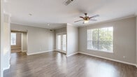 Located at 12025 Richmond Ave in Houston, TX, this single-story, 4-bedroom, 2-bathroom home offers a well-designed layout with a comfortable and functional living experience. The spacious living room features durable hardwood-style flooring, crown molding, a ceiling fan with light fixture, and large windows that invite abundant natural light and views of surrounding greenery. French doors provide an additional access point, enhancing the open feel of the space. The kitchen is equipped with gray shaker-style cabinetry, light quartz countertops, a stainless steel sink, and stainless steel appliances including an electric range, built-in microwave, and dishwasher. The four bedrooms are carpeted for comfort, each featuring ceiling fans and windows with outdoor views. The generously sized primary bedroom includes a walk-in closet with wire shelving. The two bathrooms are finished with gray vanity cabinetry, quartz countertops, and tiled tub-shower combinations. A dedicated in-unit laundry room with wire shelving adds everyday convenience. With neutral tones throughout and three closets total, this home offers practical storage and a clean, cohesive aesthetic.